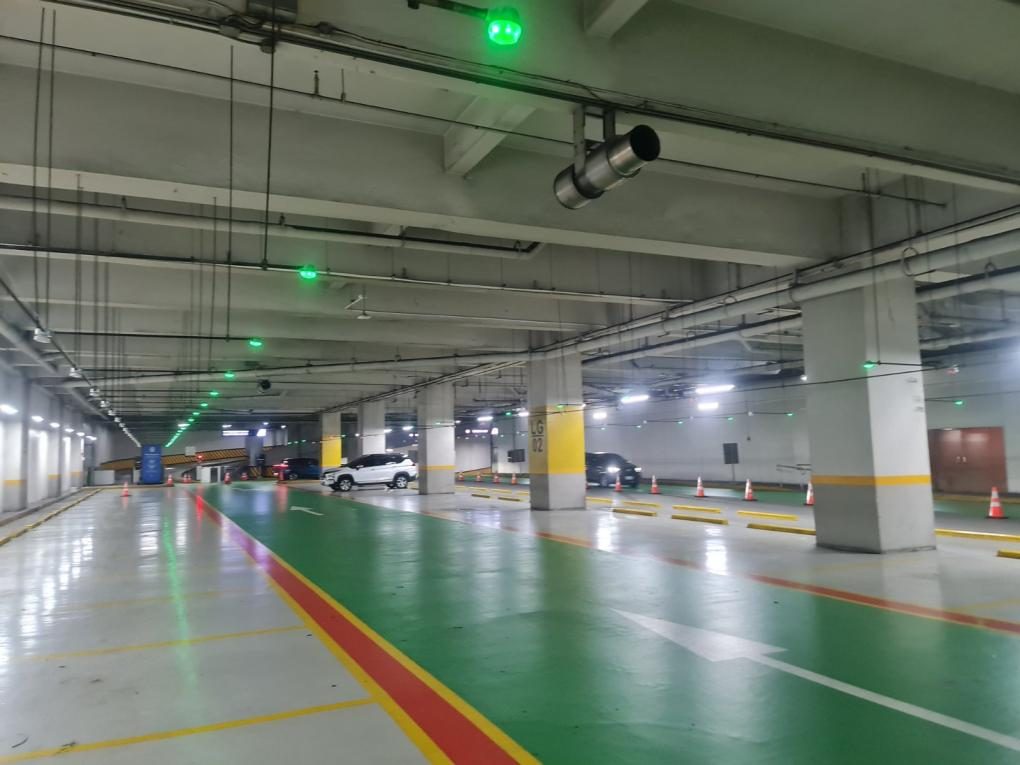 Parking garage with green guidance lights at SM Aura